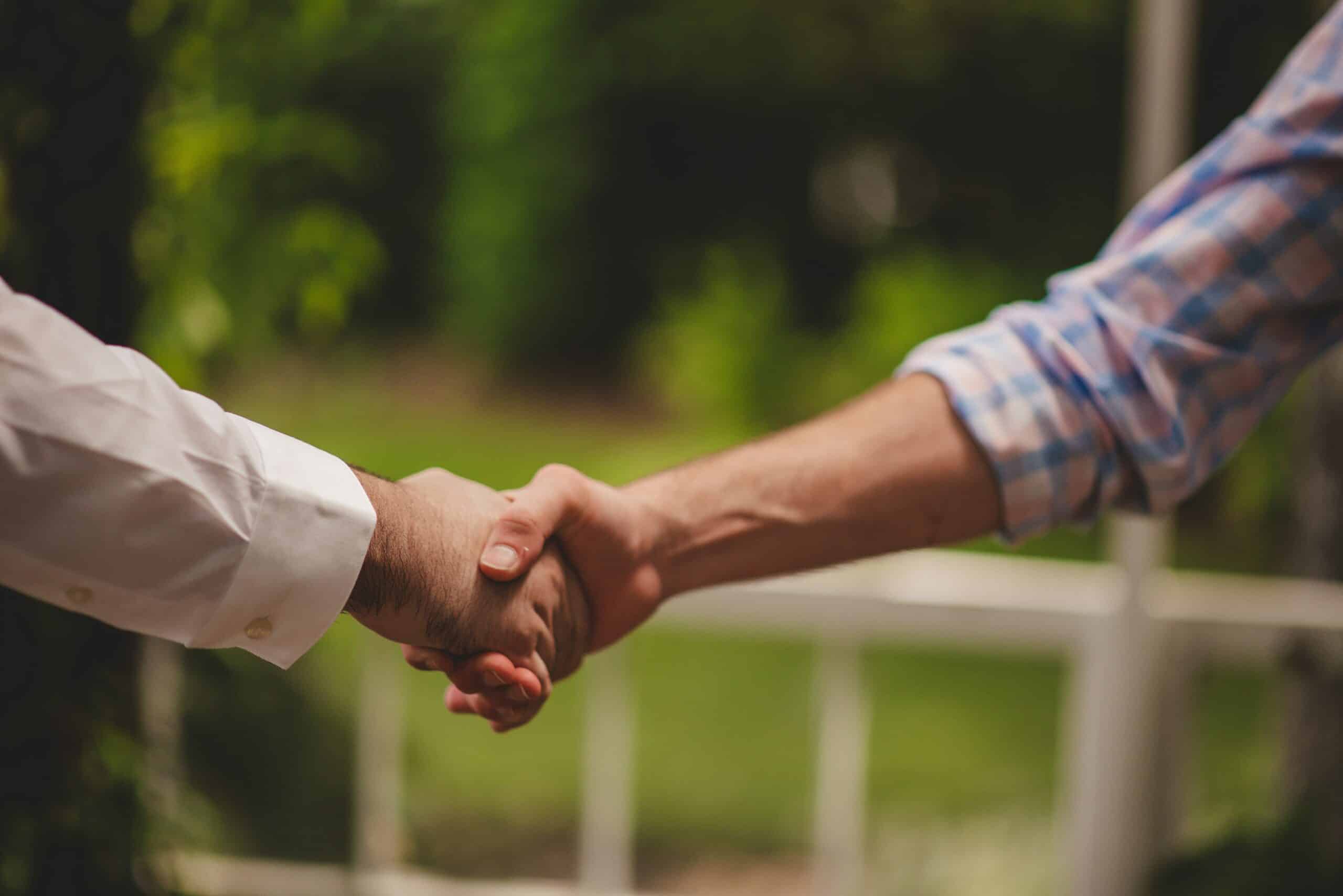 people-shaking-hands-after-buying-a-car-bill-of-sales